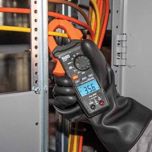klein cl220 3 HVAC technician using a clamp meter to test voltage inside an electrical panel