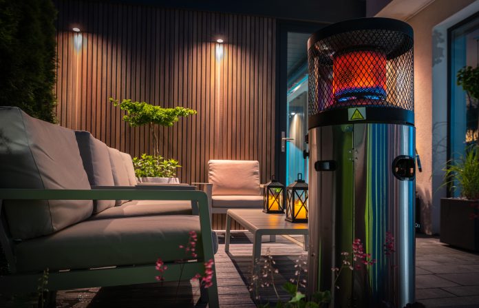 Outdoor patio heater warming a furnished seating area