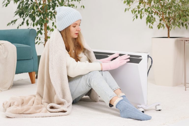 Woman keeping warm in a cozy indoor setting