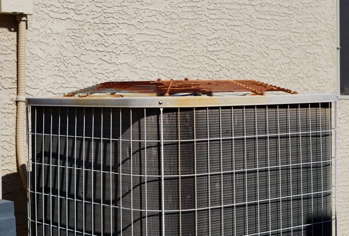 Central air conditioning unit installed outside a suburban home