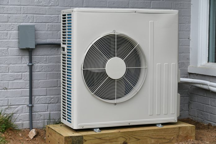 Central air conditioner condenser unit outside a home