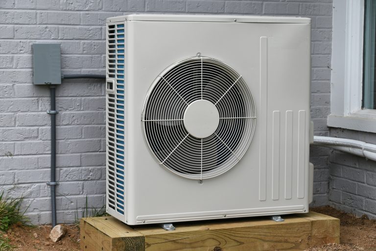 Central air conditioner condenser unit outside a home