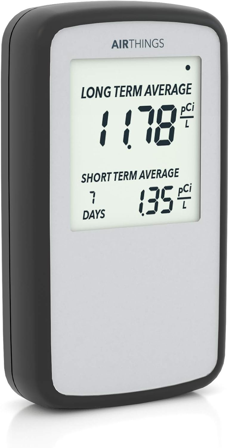 Airthings Corentium Home 223 battery-powered digital radon detector showing on-screen pCi/L reading