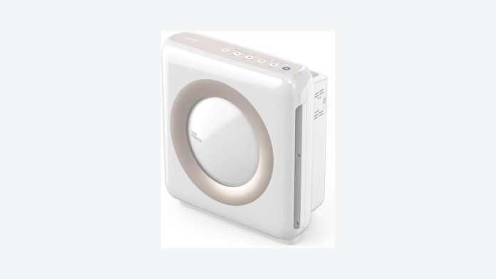 White air purifier clearing smoke haze from a bright living room