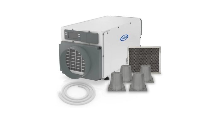 Whole-house dehumidifier on a basement floor ducted into HVAC ductwork